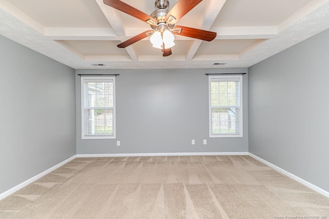 empty room with plenty of natural light, baseboards, and coffered ceiling