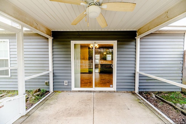 view of exterior entry featuring a patio and ceiling fan