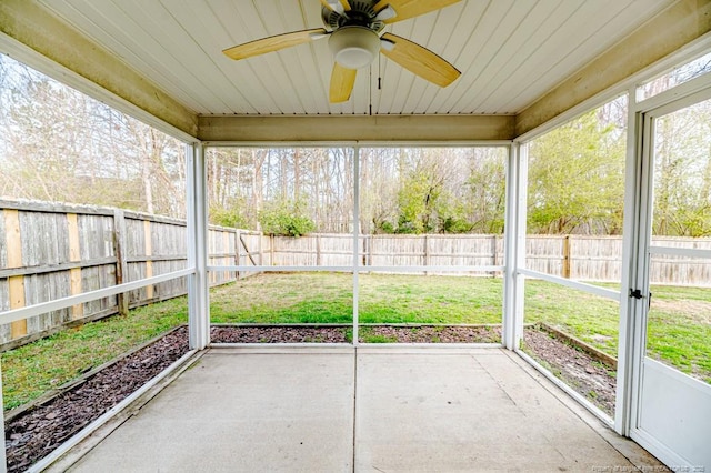 unfurnished sunroom featuring plenty of natural light and a ceiling fan