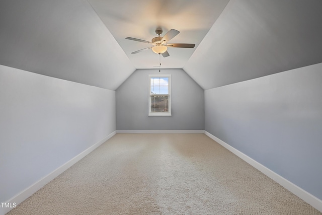 bonus room featuring lofted ceiling, baseboards, and ceiling fan