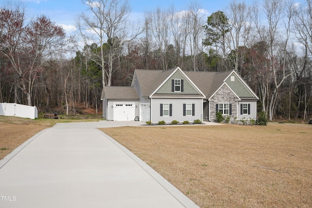 craftsman house with a garage, a front lawn, driveway, and fence