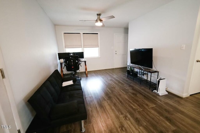 living room with wood finished floors, a ceiling fan, and baseboards