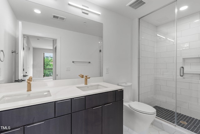 bathroom featuring visible vents, a stall shower, toilet, and a sink