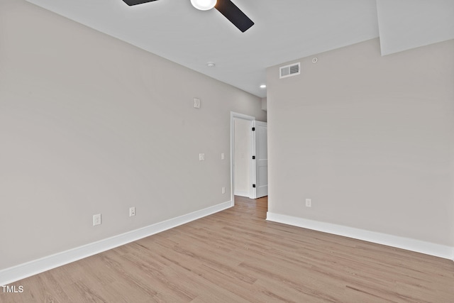 unfurnished room featuring visible vents, baseboards, a ceiling fan, and wood finished floors