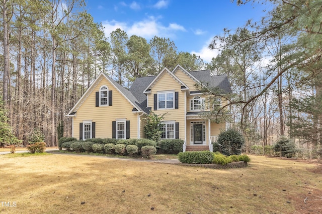 traditional-style house with a front lawn