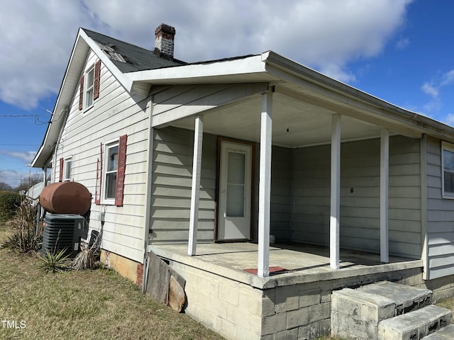 990 County Home Rd, Blanch, NC 27212 - view of side of property with central AC unit, crawl space, and a chimney
