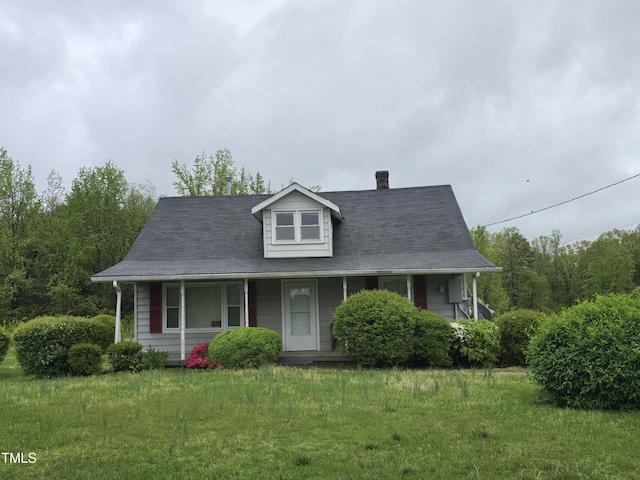 990 County Home Rd, Blanch, NC 27212 - farmhouse-style home with a front yard, covered porch, and a chimney