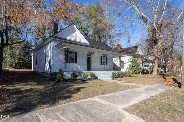 bungalow-style home with a porch and a front lawn