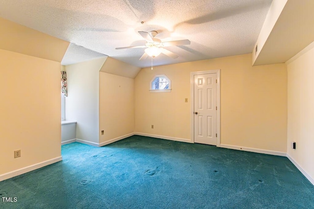 bonus room with baseboards, ceiling fan, vaulted ceiling, a textured ceiling, and carpet flooring