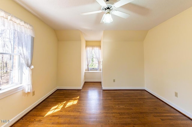 empty room with ceiling fan, baseboards, and wood finished floors