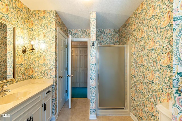 full bathroom with wallpapered walls, a stall shower, tile patterned flooring, and a textured ceiling