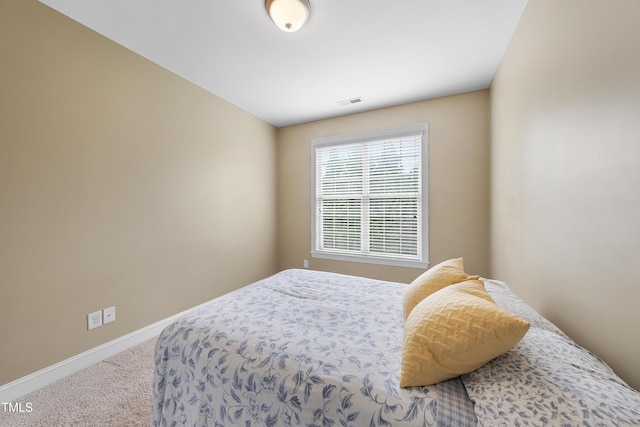 bedroom with carpet and baseboards