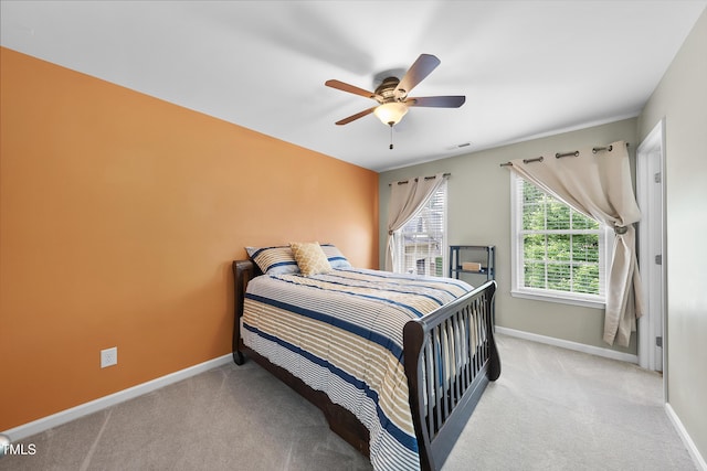 carpeted bedroom with baseboards and a ceiling fan