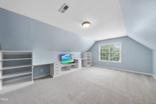 additional living space featuring carpet flooring, vaulted ceiling, and baseboards