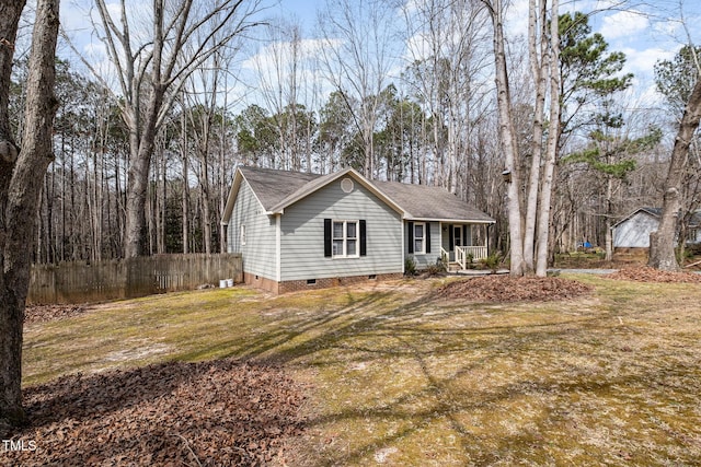 view of front of property with a front lawn, a porch, fence, a shingled roof, and crawl space