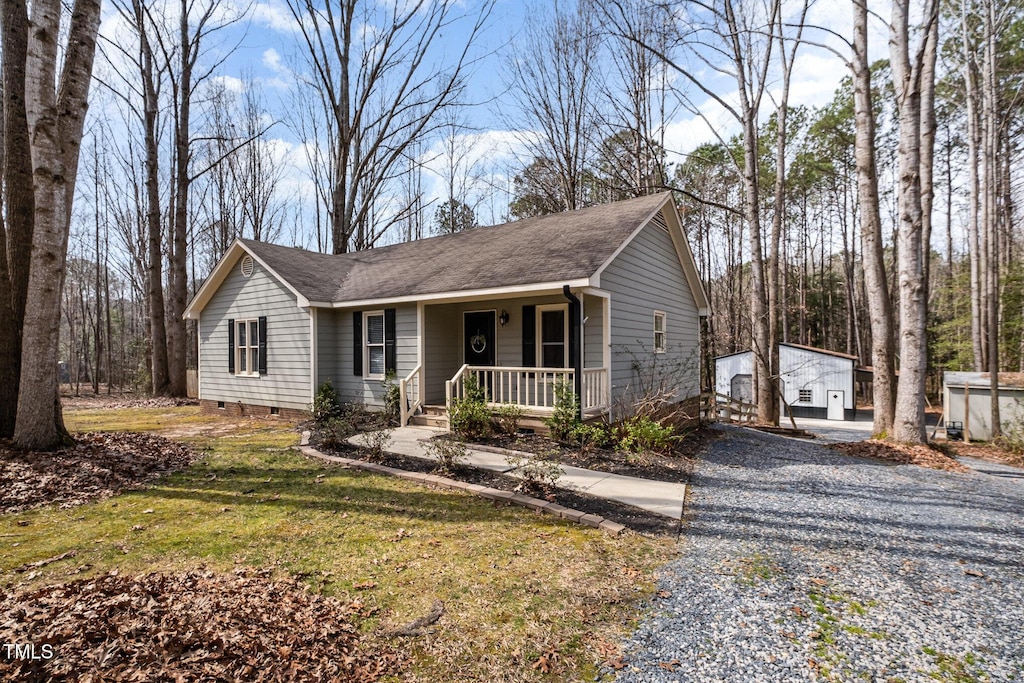 single story home with a porch, a front lawn, roof with shingles, and crawl space