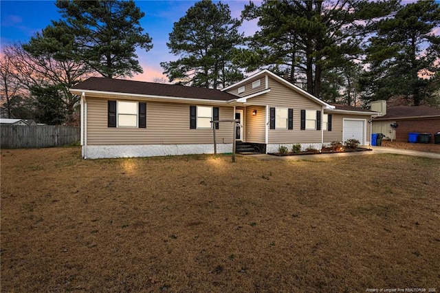 single story home with a lawn, an attached garage, concrete driveway, and fence