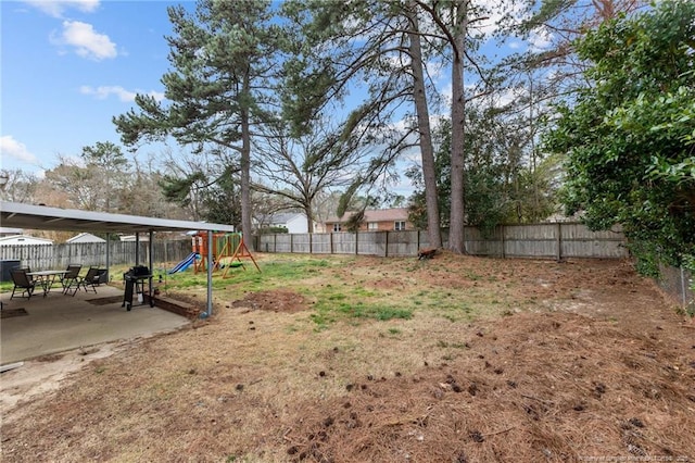 view of yard with a fenced backyard, a playground, and a patio