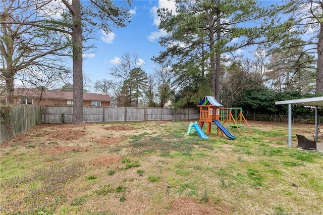 view of yard with a playground and a fenced backyard