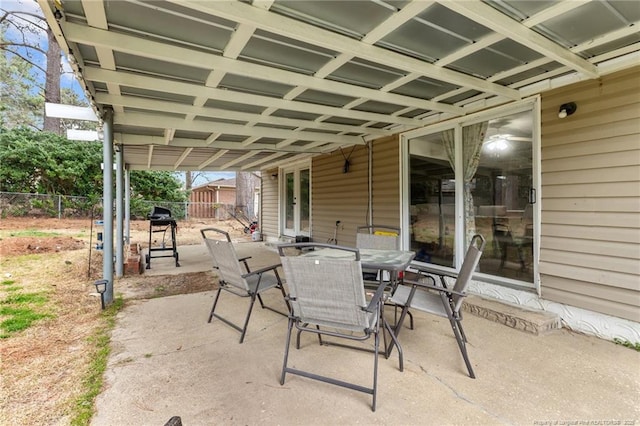 view of patio with outdoor dining area and fence