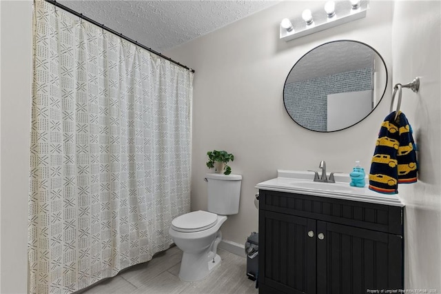 bathroom featuring baseboards, toilet, vanity, a shower with curtain, and a textured ceiling