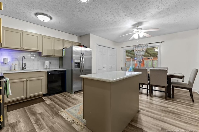 kitchen featuring wood finished floors, stainless steel fridge with ice dispenser, a sink, black dishwasher, and tasteful backsplash