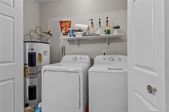 clothes washing area featuring water heater, laundry area, and washer and clothes dryer