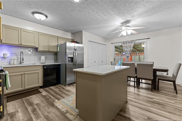kitchen featuring stainless steel fridge with ice dispenser, black dishwasher, decorative backsplash, wood finished floors, and a sink