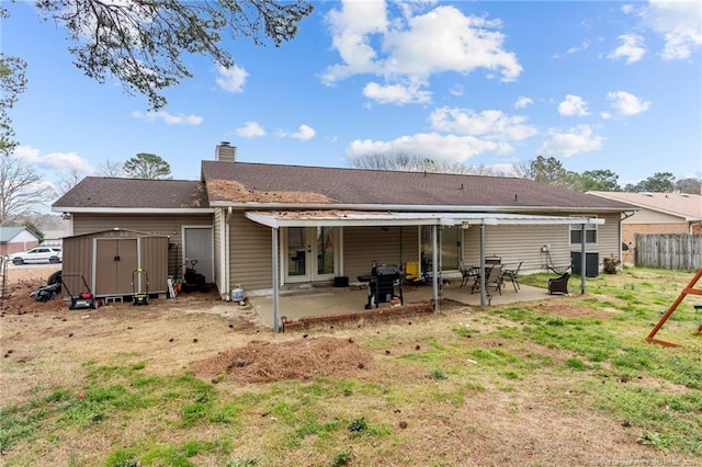 rear view of house featuring a patio, fence, a shed, an outdoor structure, and central air condition unit