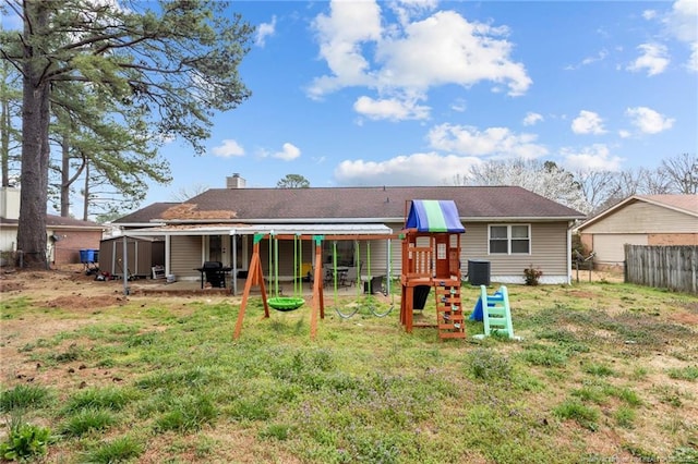 back of property featuring a storage unit, central air condition unit, fence, a playground, and an outdoor structure