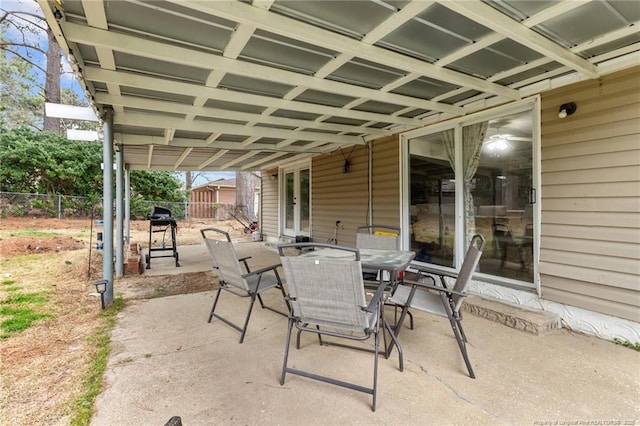 view of patio featuring outdoor dining area and fence