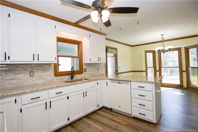 kitchen with dark wood-style floors, dishwasher, a peninsula, and a sink