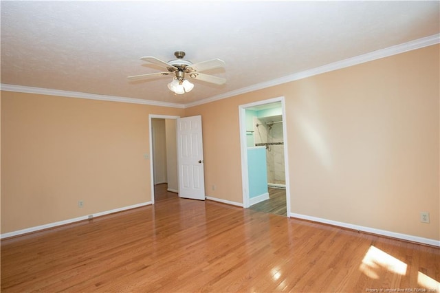 empty room with a ceiling fan, wood finished floors, and baseboards