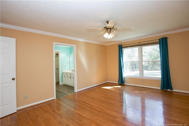 unfurnished room with ceiling fan, baseboards, wood finished floors, and crown molding