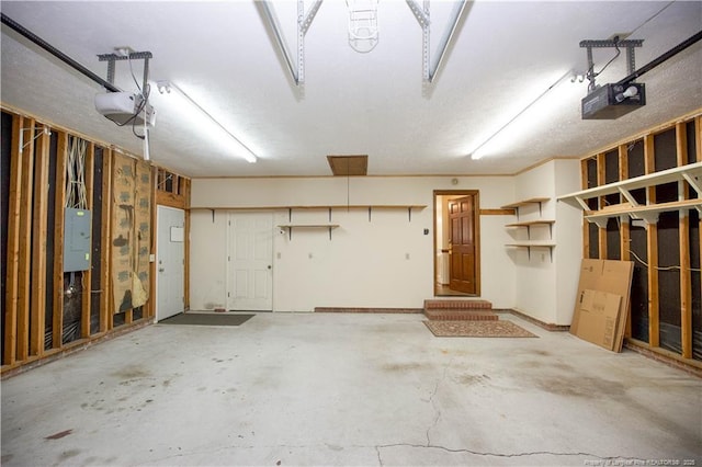 garage featuring electric panel and a garage door opener