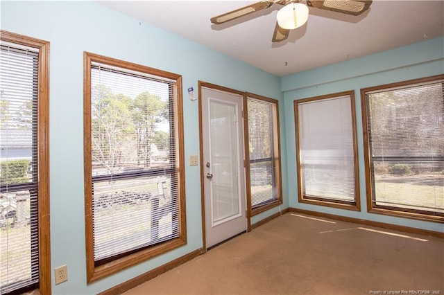 doorway to outside with carpet flooring, baseboards, and ceiling fan