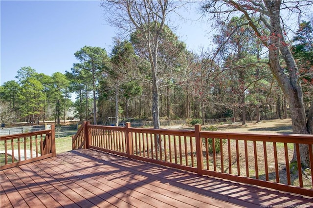 wooden terrace featuring fence