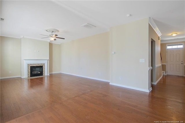 unfurnished living room featuring baseboards, wood finished floors, a ceiling fan, and ornamental molding