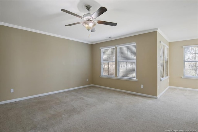 spare room with visible vents, crown molding, ceiling fan, baseboards, and light carpet