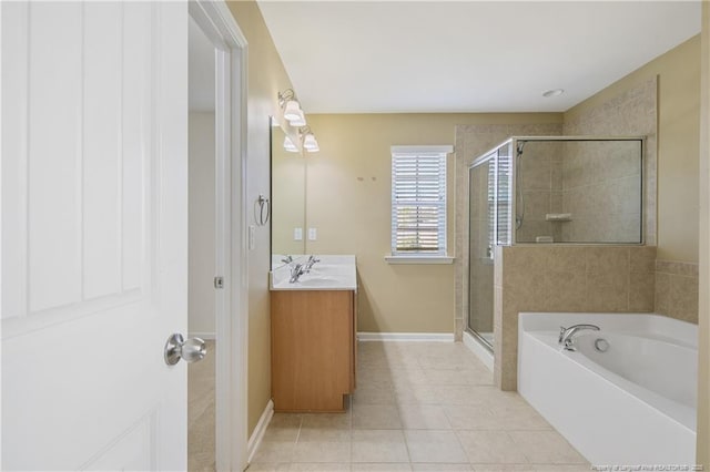 full bathroom featuring a shower stall, baseboards, a garden tub, tile patterned floors, and vanity