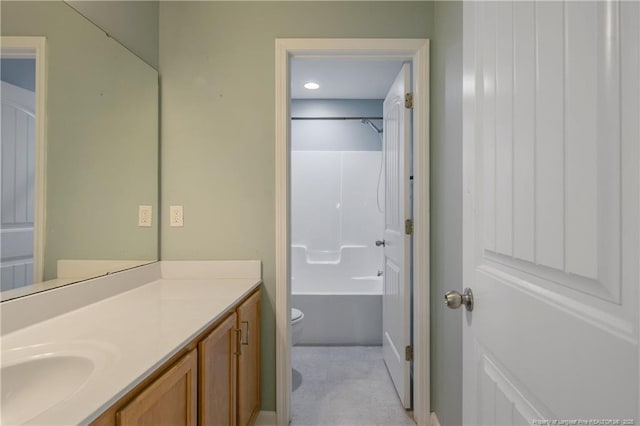 bathroom with toilet, bathtub / shower combination, and vanity