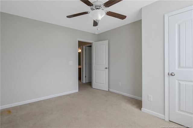 unfurnished bedroom with light colored carpet, baseboards, and ceiling fan