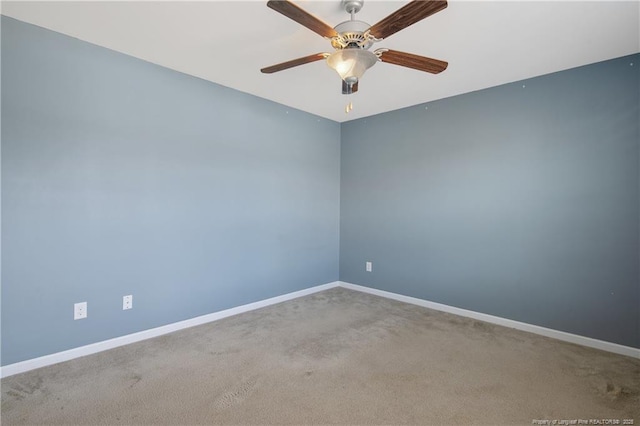 empty room featuring carpet, baseboards, and ceiling fan