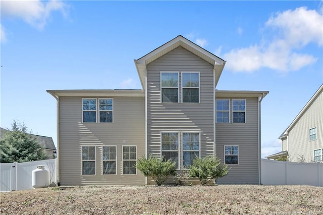 rear view of property with fence