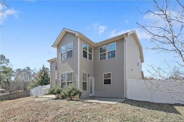 rear view of property with a patio and a fenced backyard