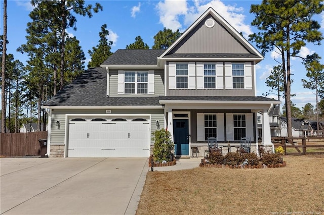 view of front facade featuring fence, driveway, covered porch, a front lawn, and a garage