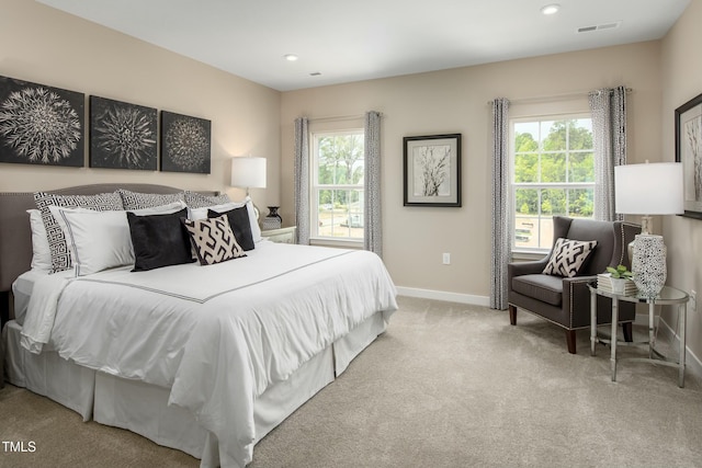 carpeted bedroom with recessed lighting, visible vents, multiple windows, and baseboards