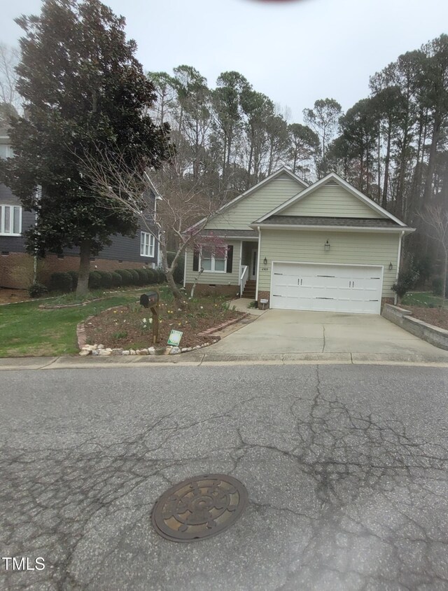 view of front of property with concrete driveway and a garage