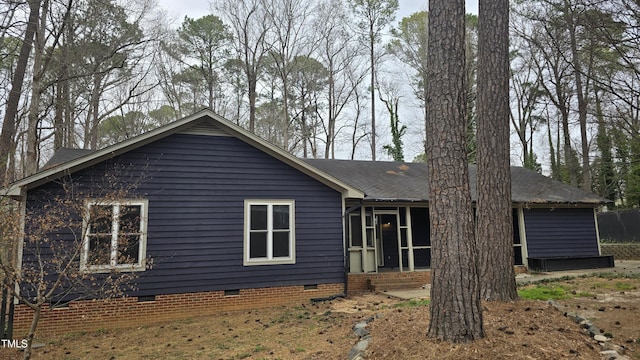 back of house featuring crawl space, entry steps, and a shingled roof