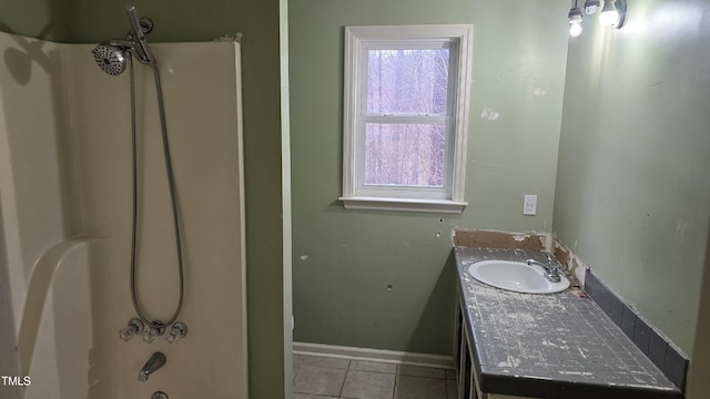 full bathroom with tile patterned flooring, shower / washtub combination, vanity, and baseboards